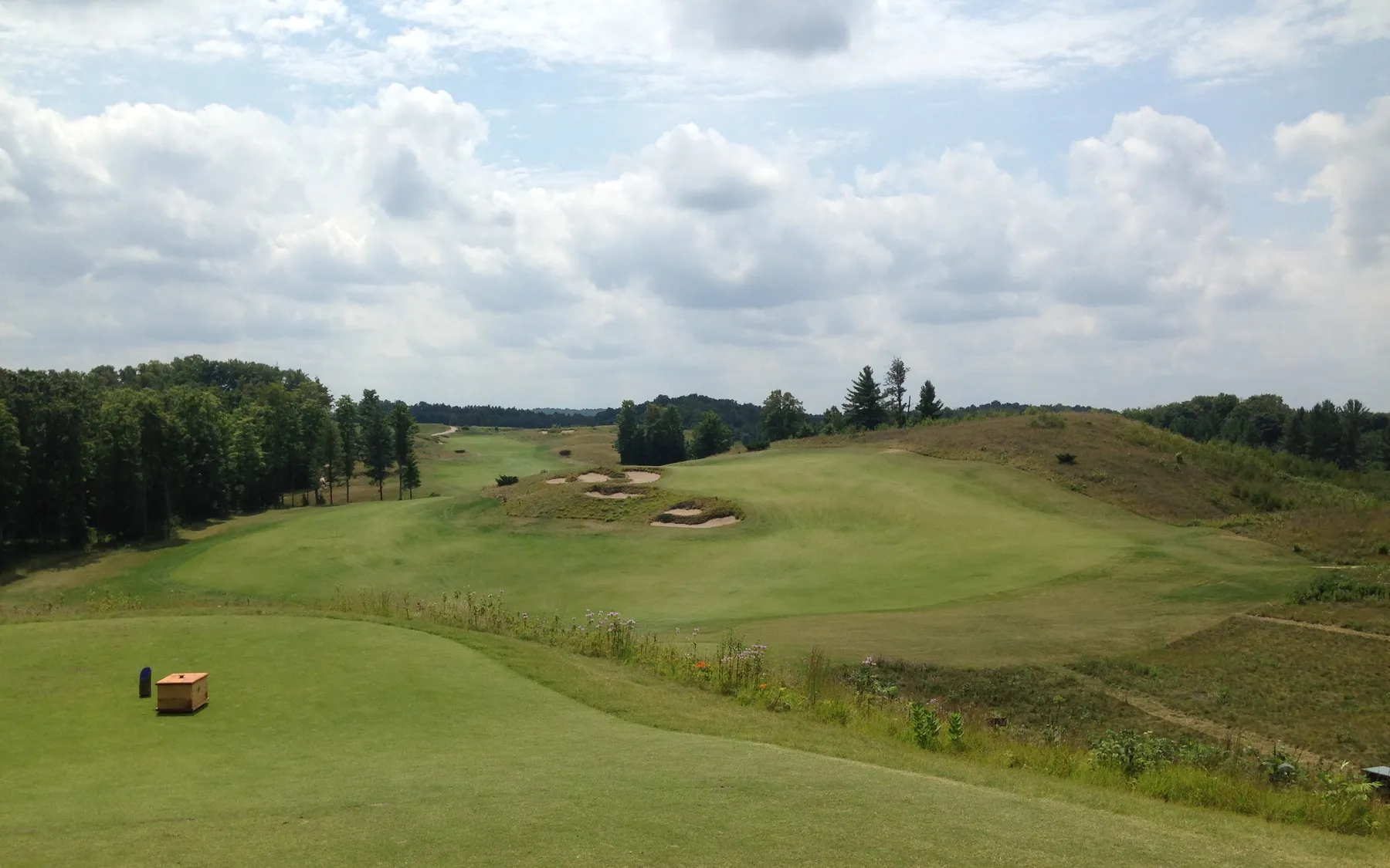 A tee box and fairway on a private golf course.