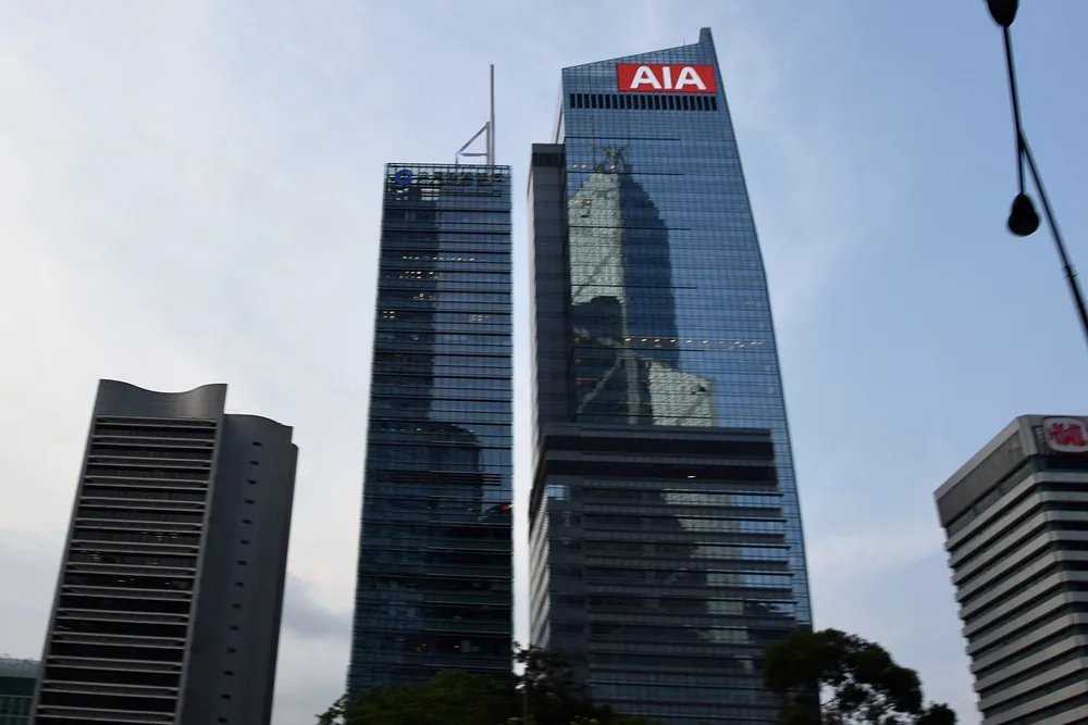 AIA Central, topped by an AIA sign, among towers in Hong Kong.