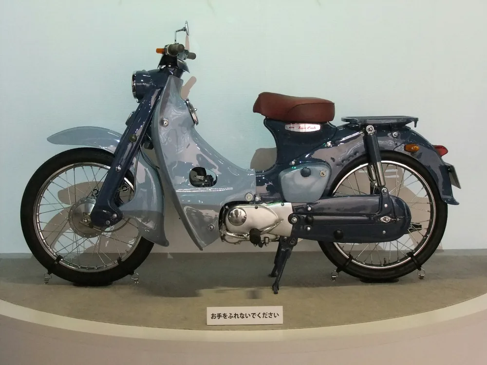 A first-generation Honda Super Cub on display.