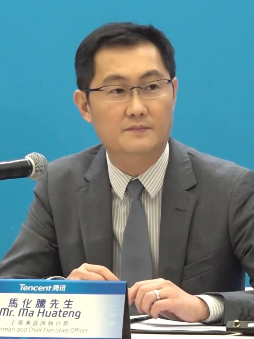 Ma Huateng seated behind a Tencent name plate in 2019.