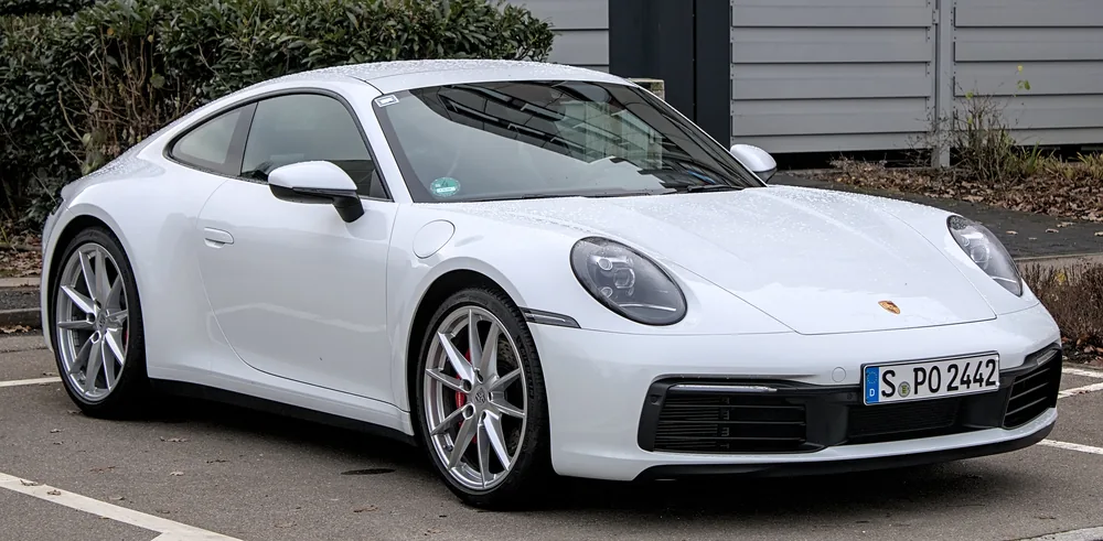 A white Porsche 911 Carrera S coupé.