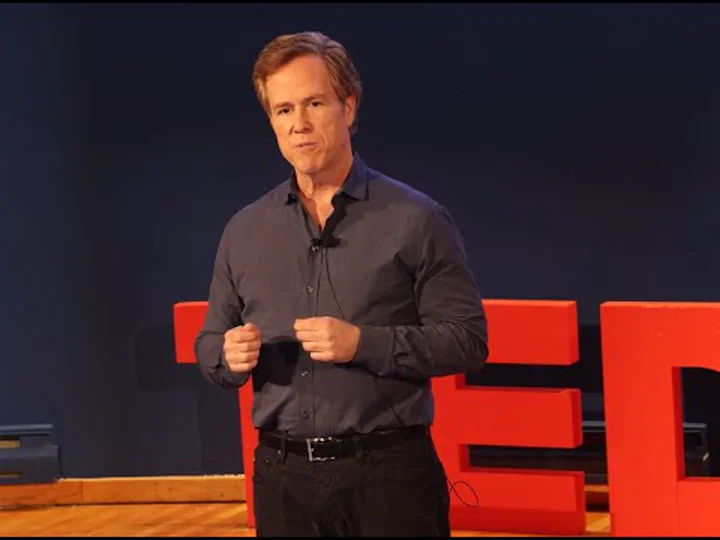 Nathan Mersereau presenting a talk about wealth and fulfilment.